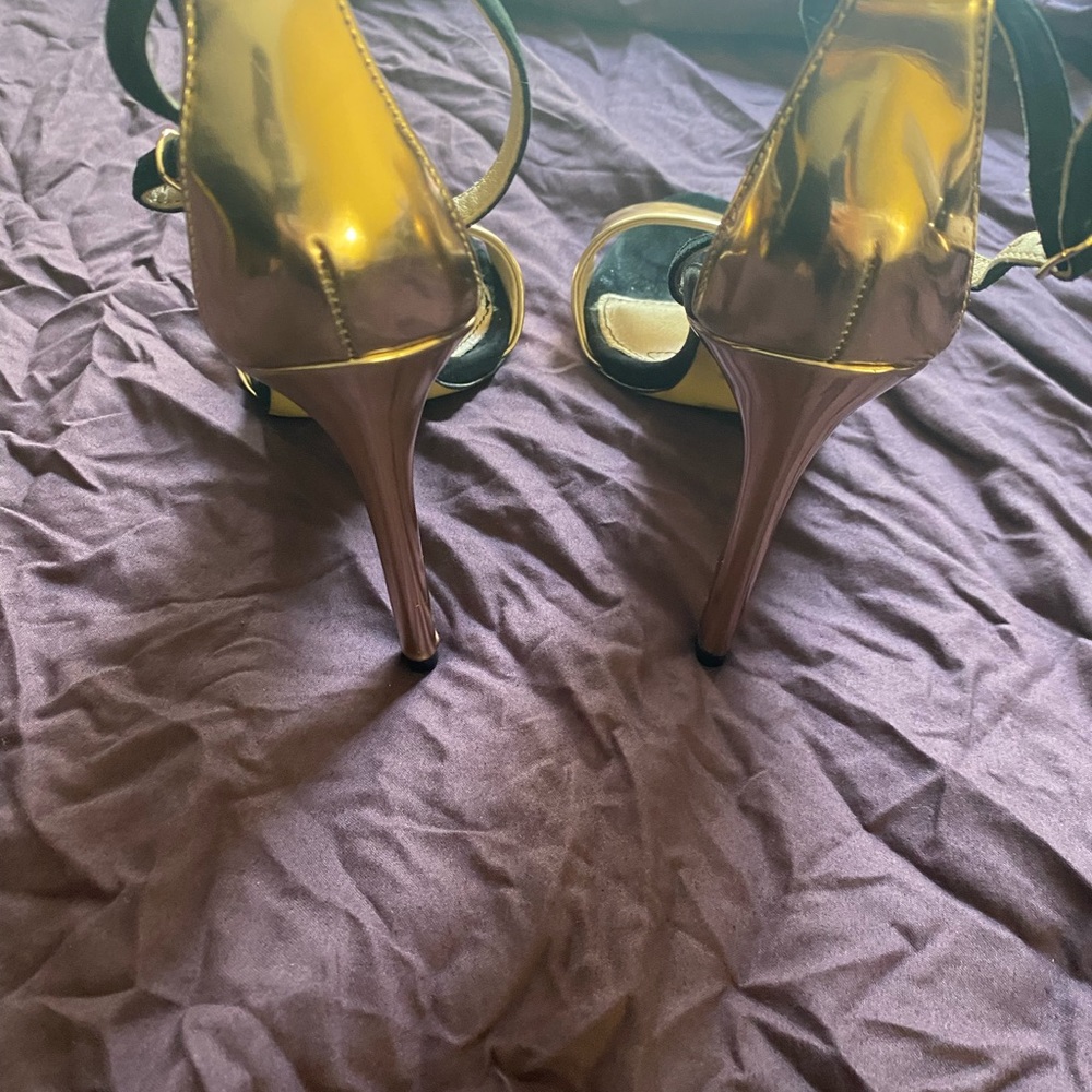 High heals sandals black and gold color.